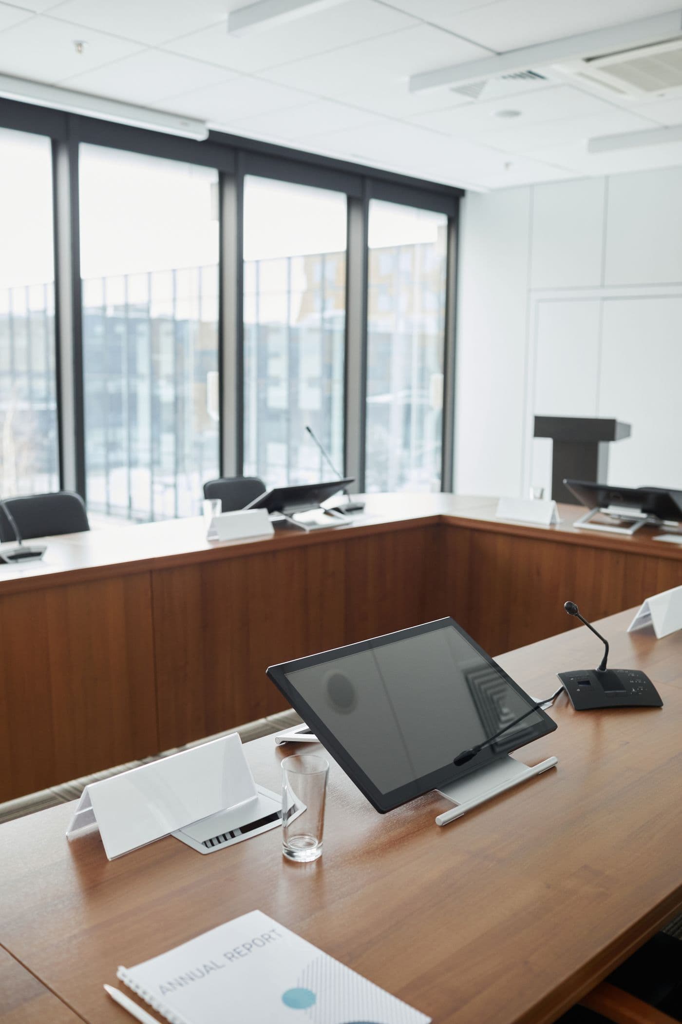 Professional conference room with individual displays and microphones