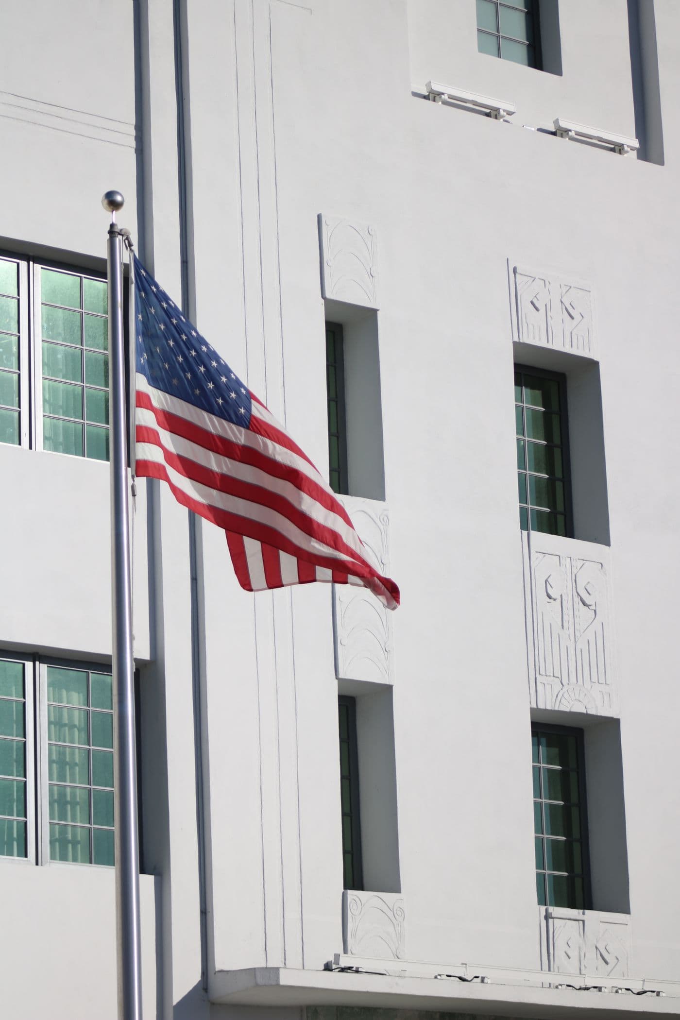 American flag flying alongside civic-style architecture